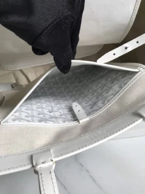 Interior view of a Goyard Tote Bag Commuter Series showing spacious compartment with protective cover and logo pattern, hand reaching inside.