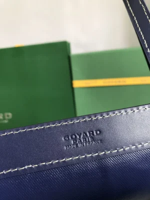 Goyard Tote Bag Commuter Series close-up, featuring logo detail and stitching, with green packaging in background, highlighting luxury craftsmanship and brand authenticity.