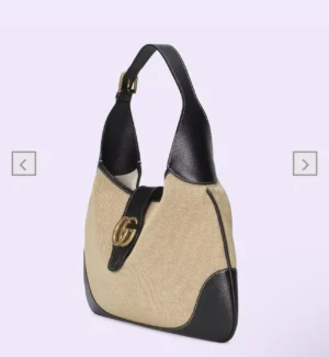 Gucci Cosmogonie Collection Small Handbag in soft leather and linen canvas, featuring double-G logo, adjustable shoulder strap, and zippered pocket.