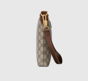 Interlocking Double G Postman Bag in beige GG Supreme canvas with brown leather strap and gold hardware, showcasing a side view.