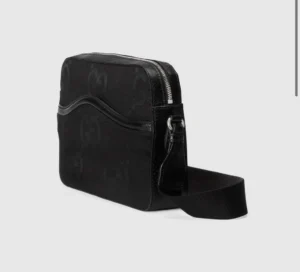 Super Double G Postman Bag in black, featuring large GG logo design, zip closure, and adjustable strap, showcased for sale at RepsGoat.