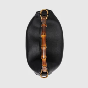 Gucci Diana Collection Medium Shoulder Bag featuring a black leather body and bamboo handle, highlighting luxury craftsmanship and unique design elements.