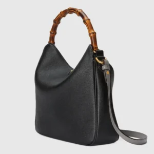 Gucci Diana Collection Medium Shoulder Bag in black leather with bamboo handle and gray shoulder strap, showcasing luxury craftsmanship and unique design features.