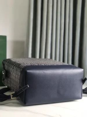 Goyard Cisalpin Backpack featuring a structured design with a textured gray canvas and smooth navy leather base, showcasing adjustable straps and a modern aesthetic, ideal for urban adventurers.