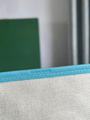 Blue leather trim and stitching detail of the Goyard Belvedere II Tote, showcasing craftsmanship with "MADE IN FRANCE" inscription.