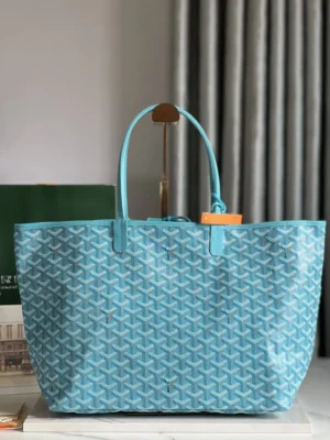 Goyard Belvedere II Tote in blue leather, featuring a textured pattern and elegant design, displayed against a neutral background, highlighting its craftsmanship and luxury appeal.