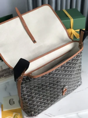 Goyard Citadin Mailman Bag in gray with tan leather accents, open showing interior compartments, highlighting functionality and style for daily use.