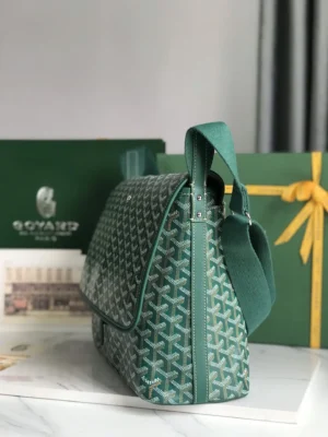 Goyard Citadin Mailman Bag in green, showcasing the signature pattern, side view with adjustable strap, placed beside branded packaging.