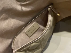 Christian Dior handbag beige quilted lambskin leather medium size with interior zip pocket and gold hardware
