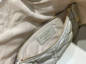 Christian Dior handbag interior beige quilted leather gold zipper made in Italy label close-up
