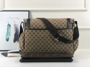 Gucci Premium GG Canvas Leather Tote bag in brown, featuring a shoulder strap and logo pattern, displayed with decorative elements.