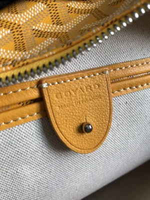 Goyard bag yellow leather trim canvas interior pouch with branded leather tag and metal stud closure