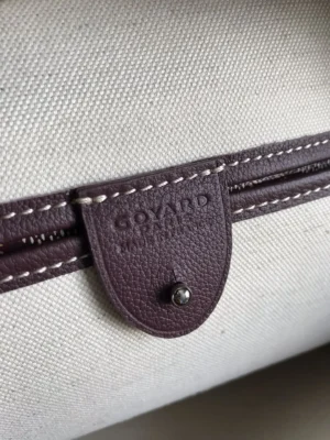 Goyard bag brown leather trim with cream canvas material and embossed logo on leather tab