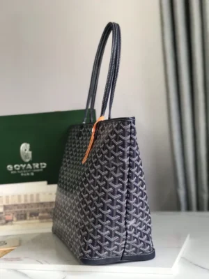 Goyard Tote bag in a stylish gray pattern, showcasing its unique design and high-quality craftsmanship, with a green Goyard box in the background.