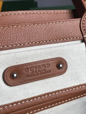 Goyard Saigon Tote bag close-up showing logo detail and leather accents, emphasizing luxury craftsmanship and brand authenticity.