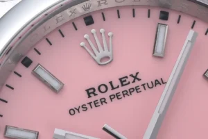 Rolex Oyster Perpetual pink dial stainless steel watch with luminescent hour markers and silver hands