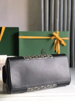 Goyard Saigon Tote bag featuring a sleek black design with signature pattern accents, set against elegant green gift boxes.