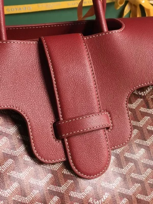 Goyard Saigon Tote bag featuring burgundy leather accents and signature logo pattern, highlighting elegant design and practical details.