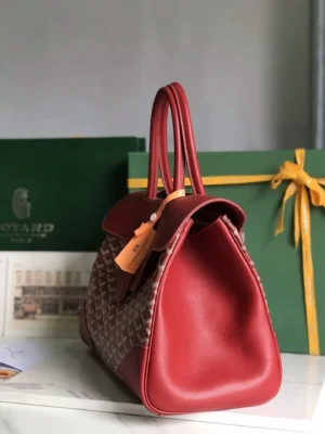 Goyard Saigon Tote bag in red leather, showcasing elegant design and practicality, with Goyard branding and green packaging in the background.