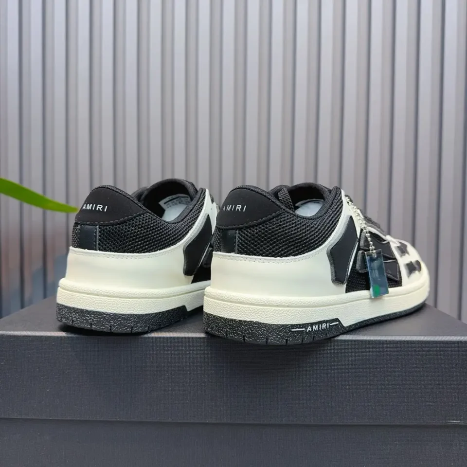 Amiri Skel Toe sneakers black white leather mesh with chain accessory on black display box