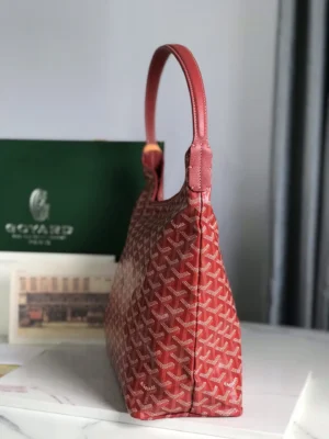 Goyard Hobo Boh è Me Stray Bag in red, showcasing its side profile and shoulder strap, with a luxury brand box in the background.