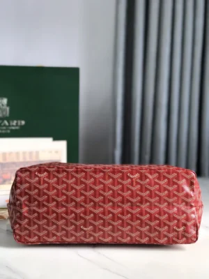 Goyard Hobo Boh è Me Stray Bag in red with signature pattern, displayed on a marble surface, emphasizing luxury design and casual style.