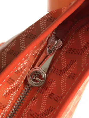 Interior view of Goyard Hobo Boh è Me Stray Bag showing vibrant orange lining and zipper detail, highlighting the bag's stylish design and quality craftsmanship.