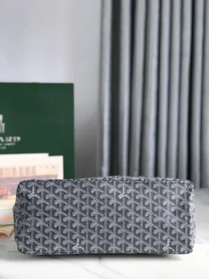 Goyard Hobo Boh è Me Stray Bag in gray with distinctive pattern, showcasing its stylish design and underarm functionality, set against a backdrop of elegant curtains and branded packaging.