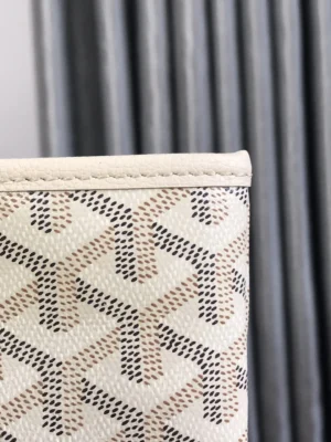 Goyard White Tote Bag close-up showcasing its unique patterned fabric and craftsmanship, emphasizing luxury and quality in design.