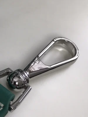 Close-up of a shiny silver clasp from the Goyard Citadin Mailman Bag, highlighting its luxury design and quality materials.