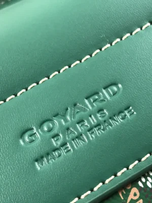 Goyard logo embossed on green leather, featuring "Goyard Paris Made in France" text, highlighting luxury craftsmanship of the Goyard Citadin Mailman Bag.