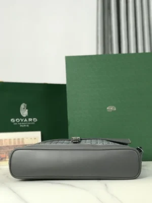 Goyard Citadin Mailman Bag displayed against green boxes, showcasing luxury craftsmanship and versatile design.