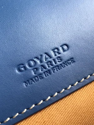 Goyard Belvedere 2nd Generation Bag logo detail featuring "Goyard Paris Made in France" embossed on blue leather, highlighting luxury craftsmanship and branding.