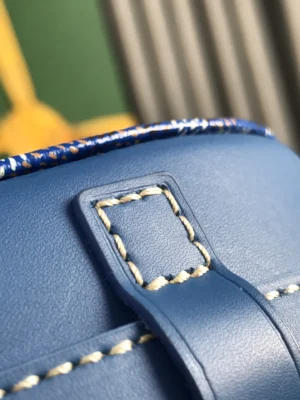 Close-up of the Goyard Belvedere 2nd Generation Bag's blue leather buckle and stitching details, showcasing elegant craftsmanship and design.