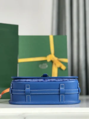 Goyard Belvedere 2nd Generation Bag in blue, showcasing elegant design, leather detailing, and practical features, displayed alongside green packaging with yellow ribbon.