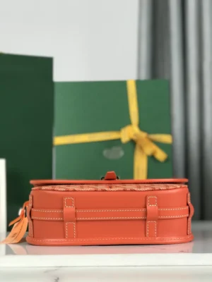 Goyard Belvedere II Bag in orange leather with matching silk ribbon gift packaging, showcasing elegant design and practical features.