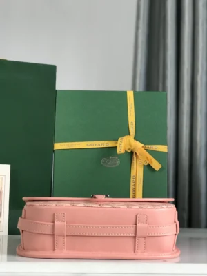 Goyard Belvedere II Sliver bag in pink leather with green packaging and yellow ribbon, showcasing luxury craftsmanship and minimalist design.