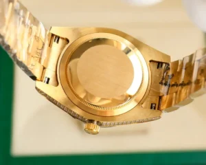 Rolex Day-Date yellow gold watch with diamond bezel stainless steel case and bracelet angled view of back side