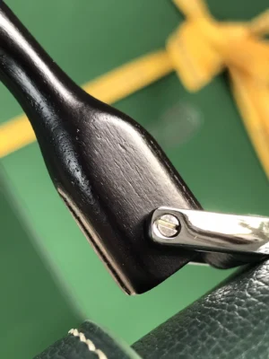 Hermès Kelly 25 bag black wooden handle silver metal hardware dark green leather trim close-up