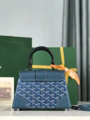 Pearl Green Goyard Sa ï gon mini bag with original packaging and box, featuring a structured design, detachable leather shoulder strap, and vibrant geometric pattern.