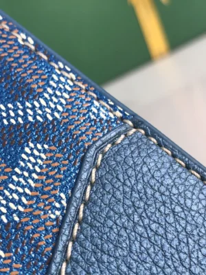 Close-up of the textured surface and stitching of a Pearl Green Goyard Sa ï gon mini bag, showcasing its craftsmanship and luxury design.