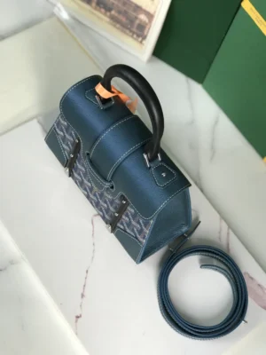 Pearl Green Goyard Sa ï gon mini bag with detachable leather shoulder strap, showcasing craftsmanship and trendy design, placed on a marble surface.