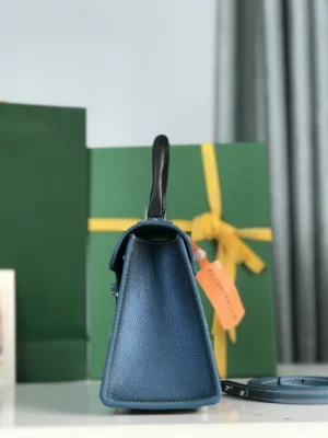 Pearl Green Goyard Sa ï gon mini bag showcasing its structured design, original packaging, and box, emphasizing luxury craftsmanship and contemporary style.