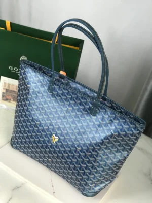 Goyard Pearl Blue tote bag featuring a distinctive patterned design, high-quality fabric and leather, and elegant handles, displayed with a branded green box.