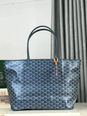 Goyard Pearl Blue tote bag featuring a distinctive pattern, dual handles, and a stylish orange accent, displayed against a neutral backdrop, highlighting its luxury design and quality craftsmanship.