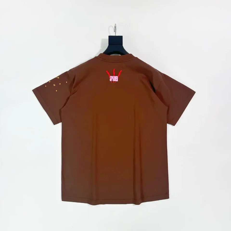 Supreme T-shirt brown cotton fabric with red and pink graphic on the back and gold star print on sleeve