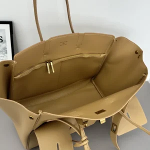 Interior view of a Balenciaga IR handbag showcasing beige leather material, spacious compartments, and minimalist design, emphasizing its practicality and stylish appeal.