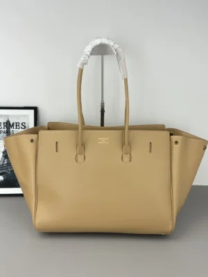 Balenciaga IR handbag in beige with a cyberpunk aesthetic, featuring front flip decoration, worn-out square locks, and leather straps, displayed on a neutral background.