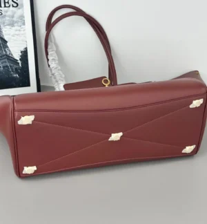 Modern City Tote Bag replica by Balenciaga, featuring a sleek design with distinctive square locks and leather straps, showcasing a futuristic aesthetic.