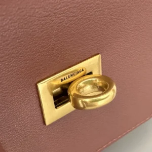 Close-up of Balenciaga bag's gold front lock with logo detail, showcasing the unique design of the Modern City Tote Bag replica.